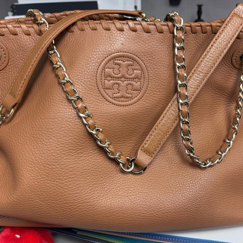 Tory Burch I bought pre loved I hardly used this bag. The leather is beautiful.